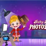 En tegneseriefigur med blondt hår i en rød kjole poserer for fotografering under studiobelysning, med teksten Baby Hazel Photoshoot i bakgrunnen