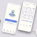 To smarttelefoner som viser en sudoku-app, plassert på et bord ved siden av en plante, en klokke og skrivesaker