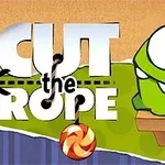 Grønn, tegneserieaktig skapning med store øyne sitter på en benk ved siden av teksten Cut the Rope med en hengende godteri