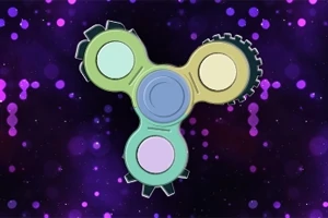 En fargerik spinner med tre armer mot en lilla bakgrunn med lysende prikker