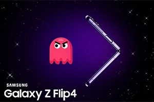 En rosa spøkelse med et sint ansikt ved siden av en Samsung Galaxy Z Flip4 på en lilla bakgrunn med stjerner