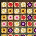Rutemønster med ulike fargerike blomster som roser, prestekrager og solsikker