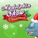 En delfin med nisselue på grønn bakgrunn med snøfnugg og tekst My dolphin Show Christmas