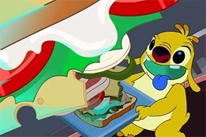 En gul animert figur med blå tunge lager en stor sandwich med ost, grønnsaker og salat