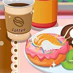 To donuts med glasur og fruktpynt ved siden av en kopp kaffe og kiwi-skiver